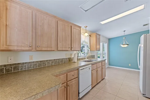 a view of a room with a ceiling fan and a window