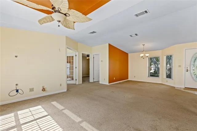 a view of an empty room with a ceiling fan