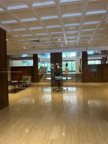 a living room with furniture and view of kitchen