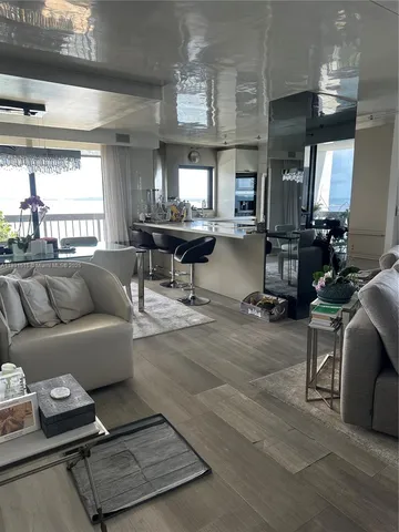 a view of a balcony with wooden floor and iron fence