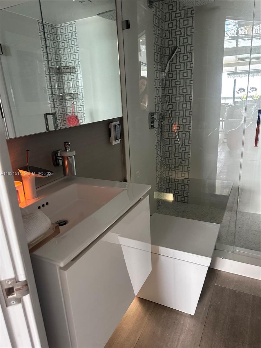 2333 Brickell Avenue, Unit 901 Miami, FL 33129 - Photo 27 of 79 a bathroom with a tub sink and mirror