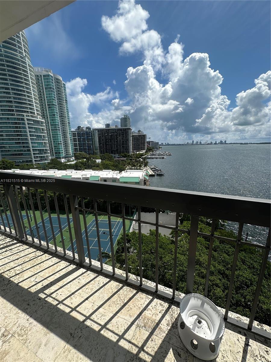 2333 Brickell Avenue, Unit 901 Miami, FL 33129 - Photo 34 of 79 a view of a balcony with wooden floor and iron fence