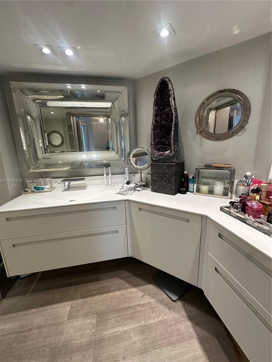 2333 Brickell Avenue, Unit 901 Miami, FL 33129 - Photo 43 of 79 a bathroom with a double vanity sink and a mirror