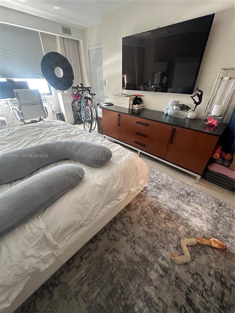 2333 Brickell Avenue, Unit 901 Miami, FL 33129 - Photo 47 of 79 a living room with furniture and a flat screen tv