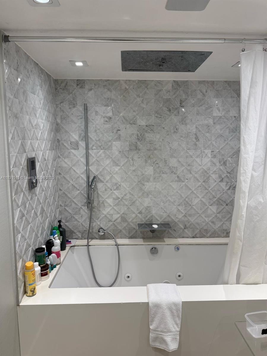 2333 Brickell Avenue, Unit 901 Miami, FL 33129 - Photo 61 of 79 a bathroom with a bathtub