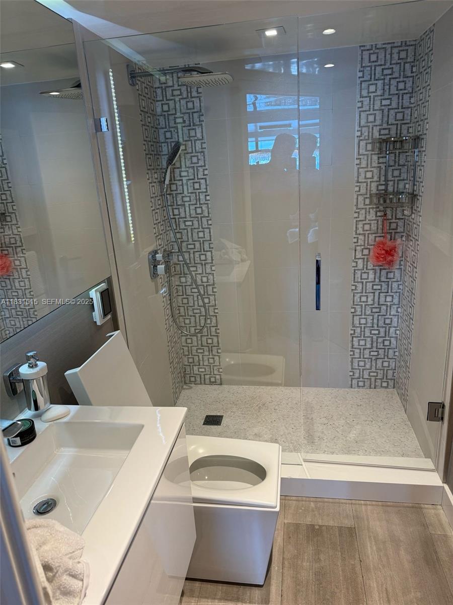 2333 Brickell Avenue, Unit 901 Miami, FL 33129 - Photo 70 of 79 a bathroom with a sink a toilet and shower