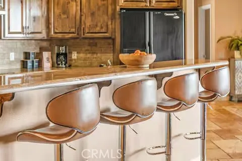 a dining room with furniture and potted plants