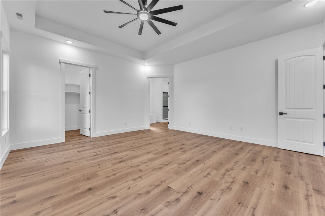 1727 Harris Bridge Road Anderson, SC 29621 - Photo 15 of 35 A tranquil primary bedroom suite with warm wood flooring and an elegant ceiling fan.