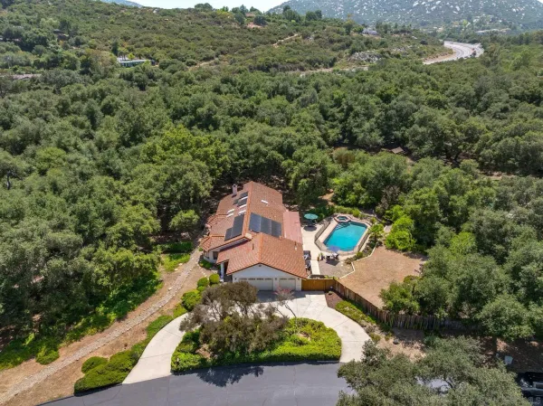 an aerial view of a house with a yard