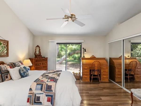 a bedroom with bed and a large window