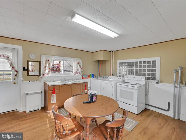 a kitchen with a table chairs stove and cabinets