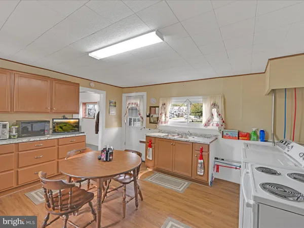 a kitchen with white cabinets and refrigerator