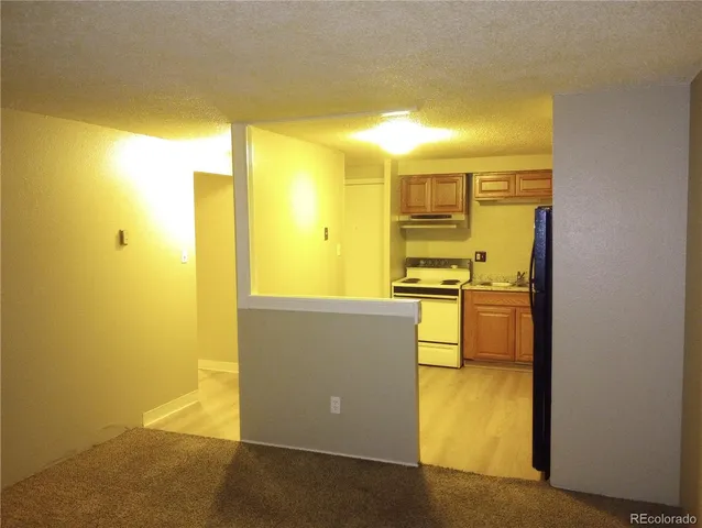 a view of a kitchen with a refrigerator