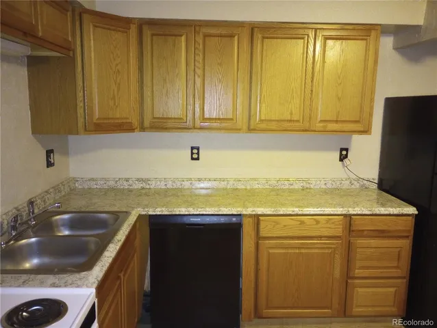 a kitchen with granite countertop a sink and cabinets