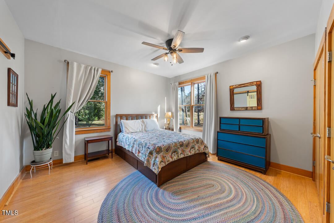 10714 Wilkins Road Rougemont, NC 27572 - Photo 11 of 40 a bedroom with a bed and a potted plant