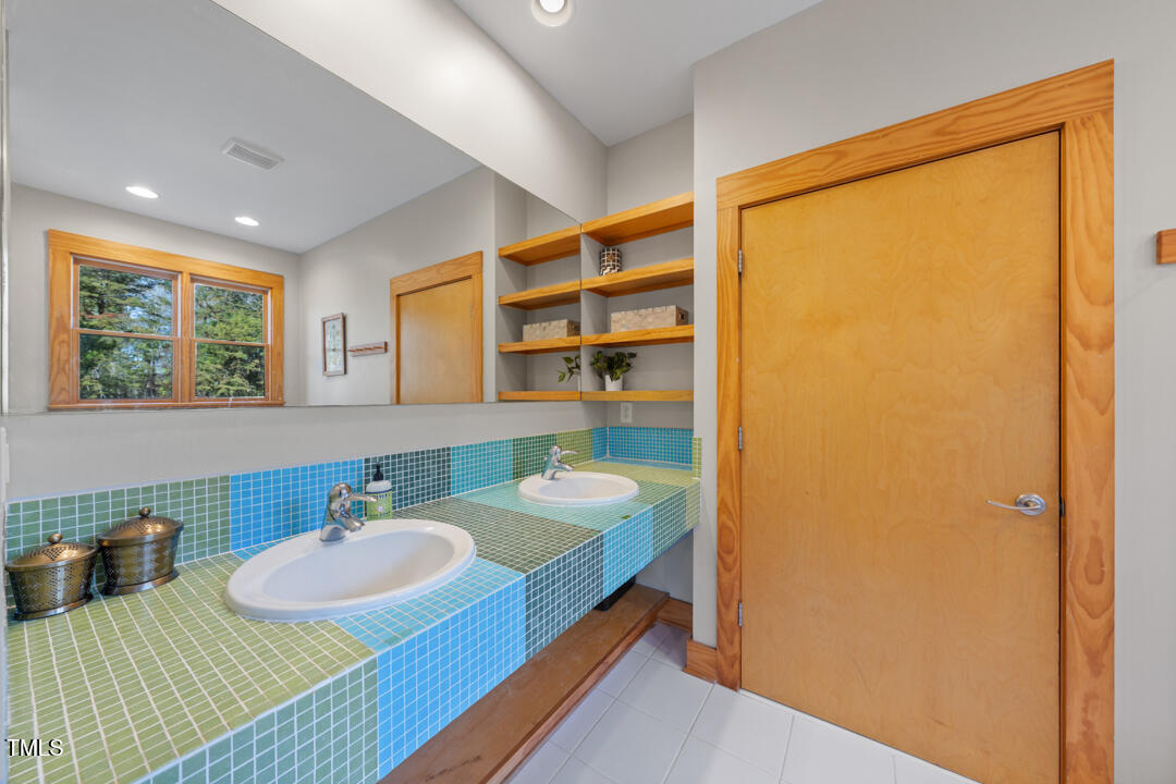 10714 Wilkins Road Rougemont, NC 27572 - Photo 12 of 40 a bathroom with a sink and a mirror