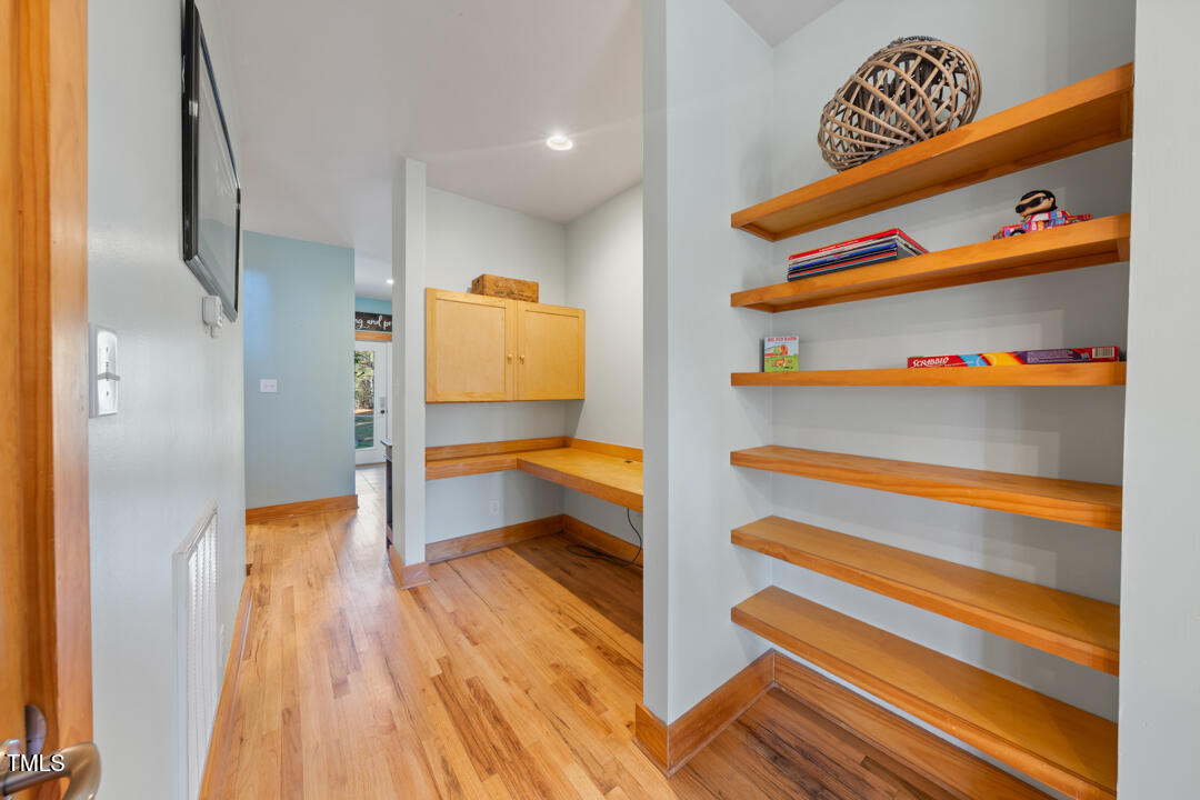 10714 Wilkins Road Rougemont, NC 27572 - Photo 16 of 40 a view of walk in closet with clothes and shoes