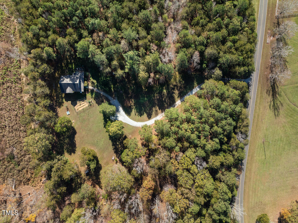 10714 Wilkins Road Rougemont, NC 27572 - Photo 2 of 40 a view of a lake with a tree