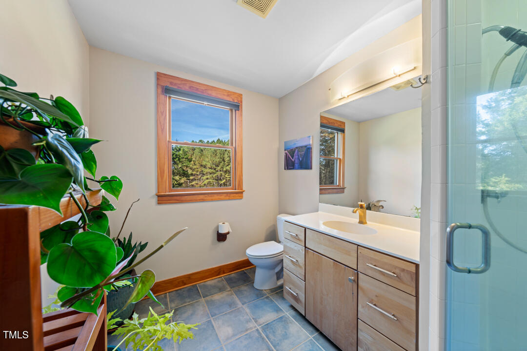 10714 Wilkins Road Rougemont, NC 27572 - Photo 23 of 40 a spacious bathroom with a granite countertop tub a sink and a large mirror