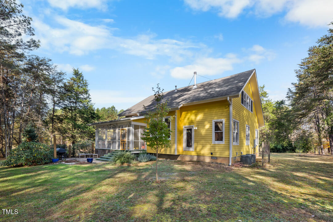 10714 Wilkins Road Rougemont, NC 27572 - Photo 27 of 40 a view of a house with a yard and garage