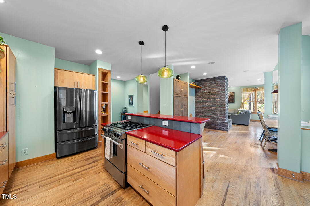 10714 Wilkins Road Rougemont, NC 27572 - Photo 5 of 40 a kitchen with stainless steel appliances granite countertop a stove a refrigerator and a wooden floors