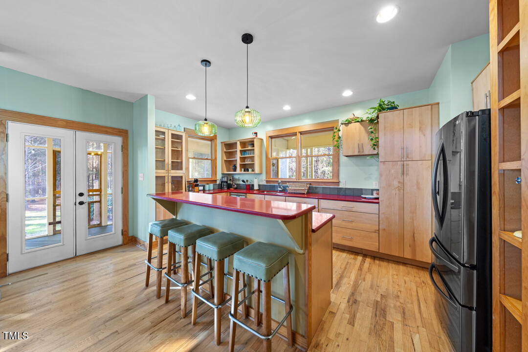 10714 Wilkins Road Rougemont, NC 27572 - Photo 6 of 40 a dining area with stainless steel appliances kitchen island granite countertop wooden floor dining table chairs and granite counter top