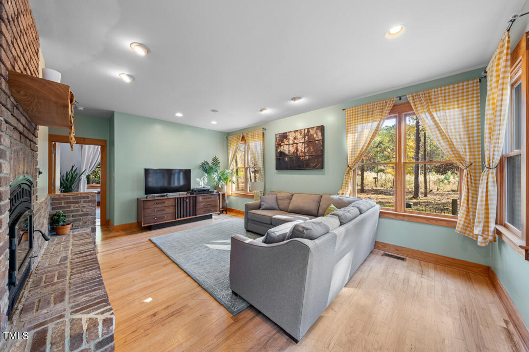 10714 Wilkins Road Rougemont, NC 27572 - Photo 10 of 40 a living room with furniture and a flat screen tv