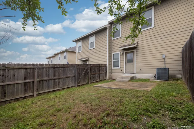 a backyard of a house with wooden fence
