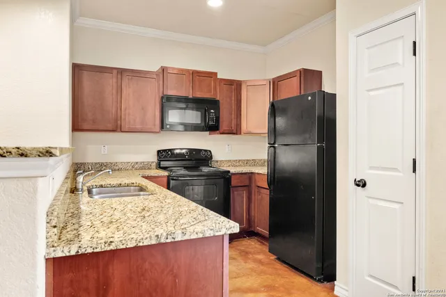 a kitchen with a refrigerator sink and microwave