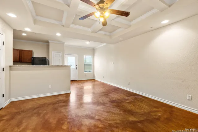a view of a kitchen with a sink and a chandelier fan
