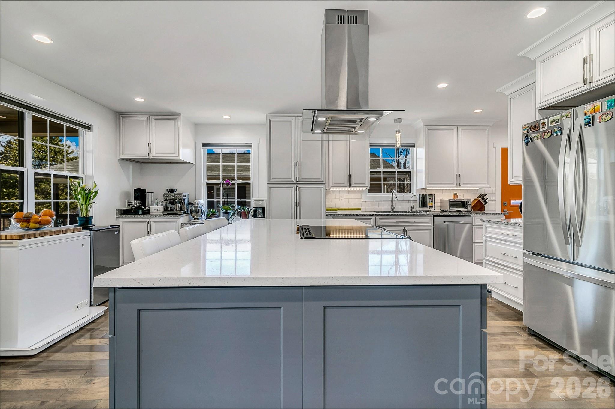 215 East Oakview Road Asheville, NC 28806 - Photo 11 of 42 a kitchen with kitchen island a sink stainless steel appliances and cabinets