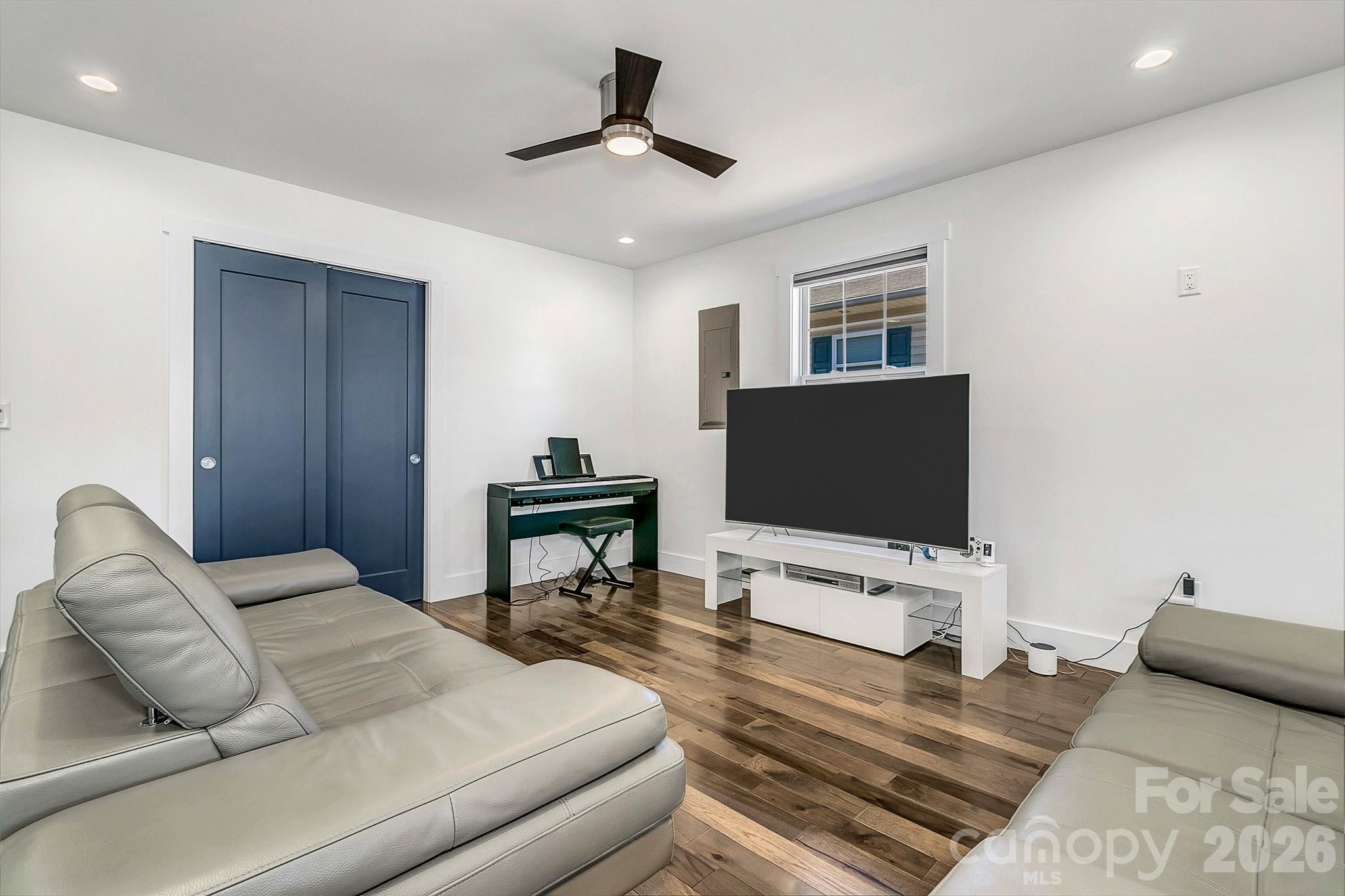 215 East Oakview Road Asheville, NC 28806 - Photo 17 of 42 a bedroom with bed and a flat screen tv
