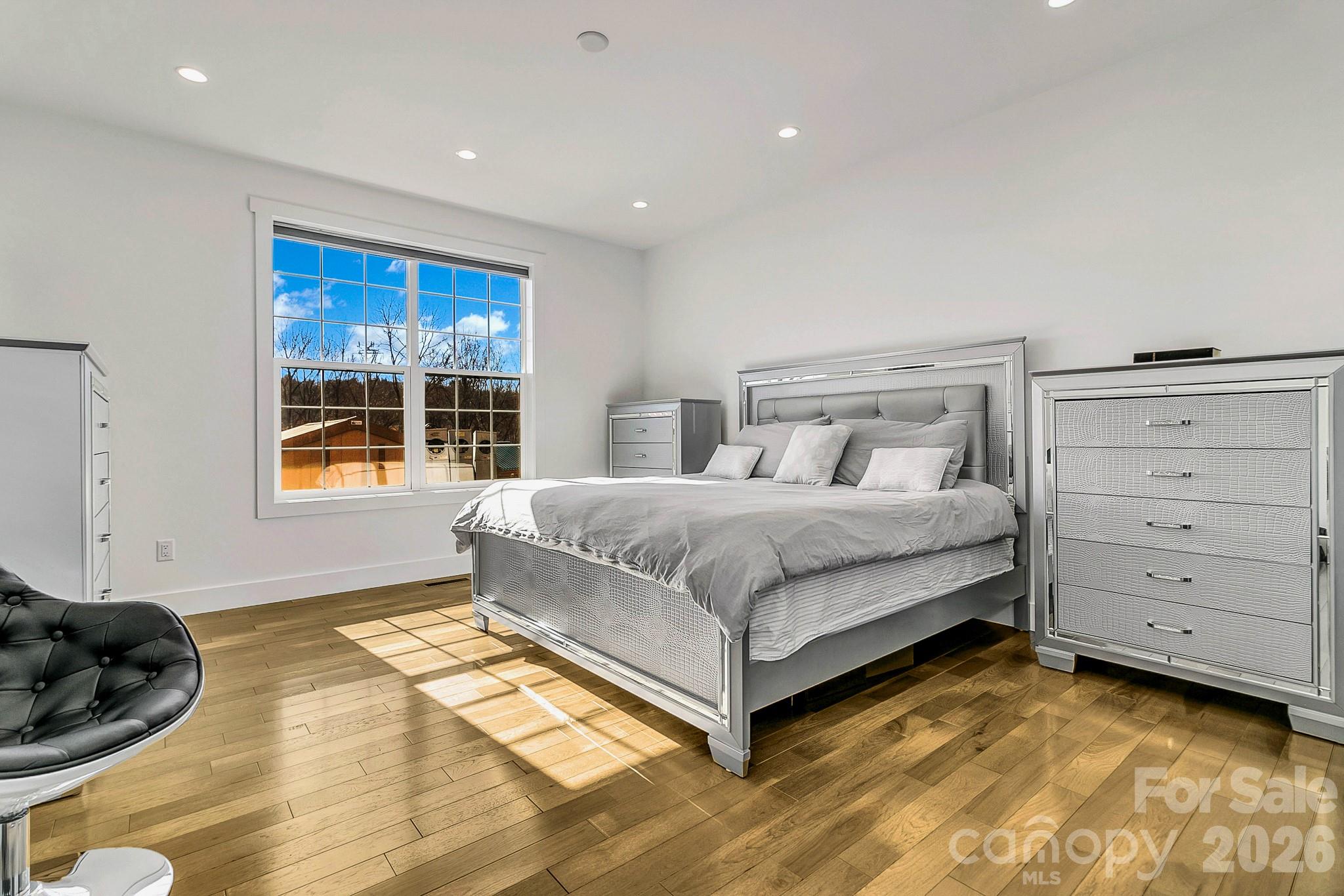 215 East Oakview Road Asheville, NC 28806 - Photo 20 of 42 a bedroom with a bed and windows