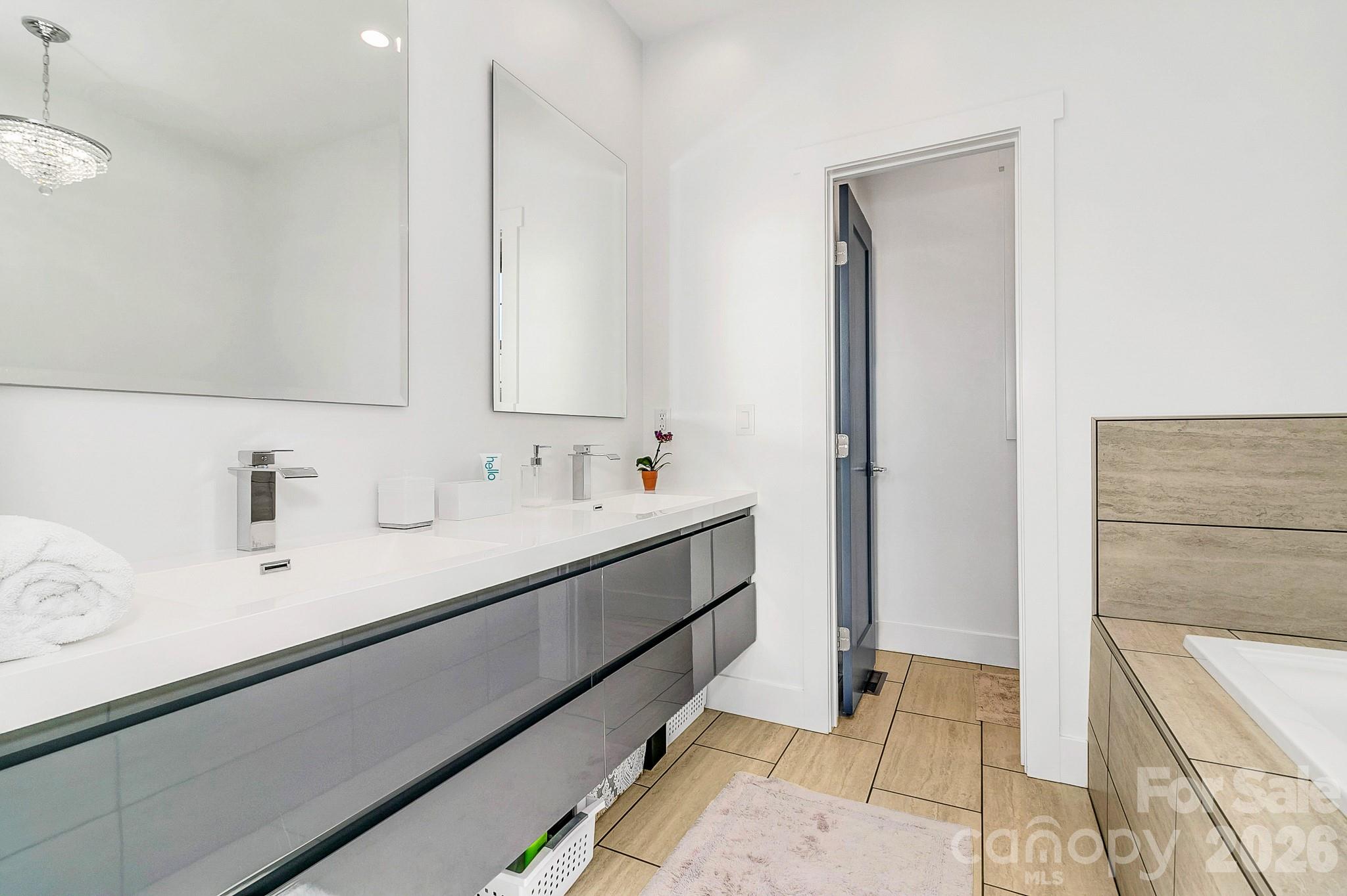 215 East Oakview Road Asheville, NC 28806 - Photo 25 of 42 a bathroom with a double vanity sink mirror and