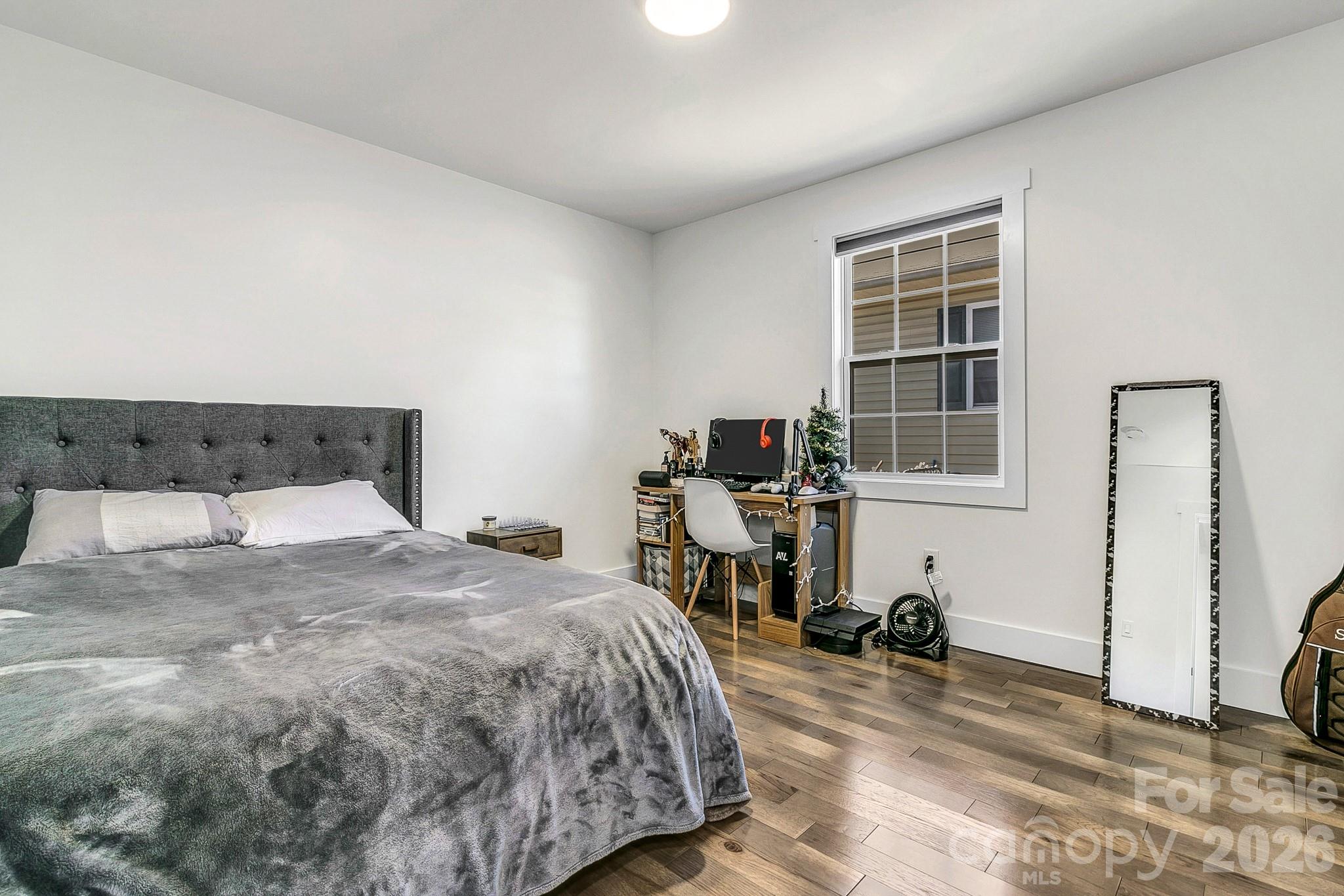 215 East Oakview Road Asheville, NC 28806 - Photo 26 of 42 a bedroom with a bed and wooden floor