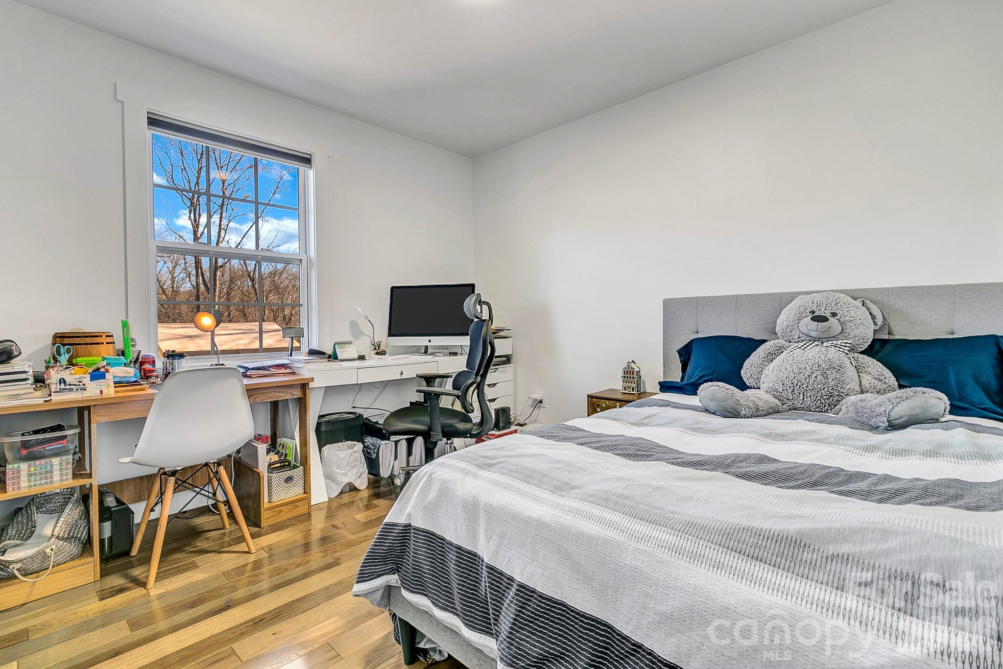 215 East Oakview Road Asheville, NC 28806 - Photo 29 of 42 a bedroom with a bed and a table