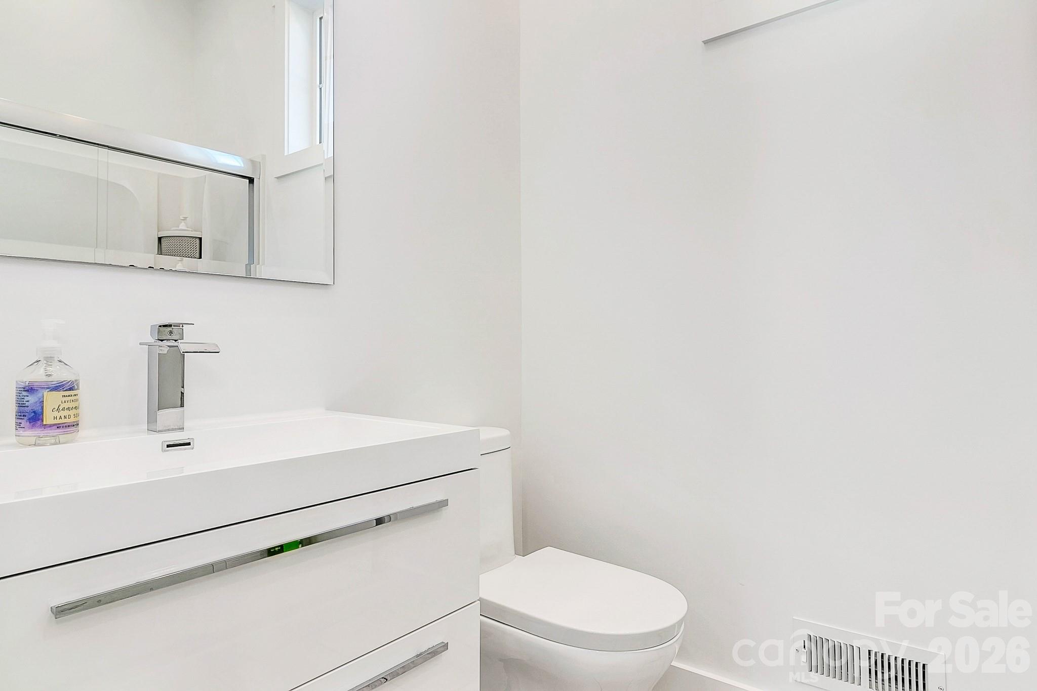 215 East Oakview Road Asheville, NC 28806 - Photo 38 of 42 a white toilet sitting next to a bathroom sink