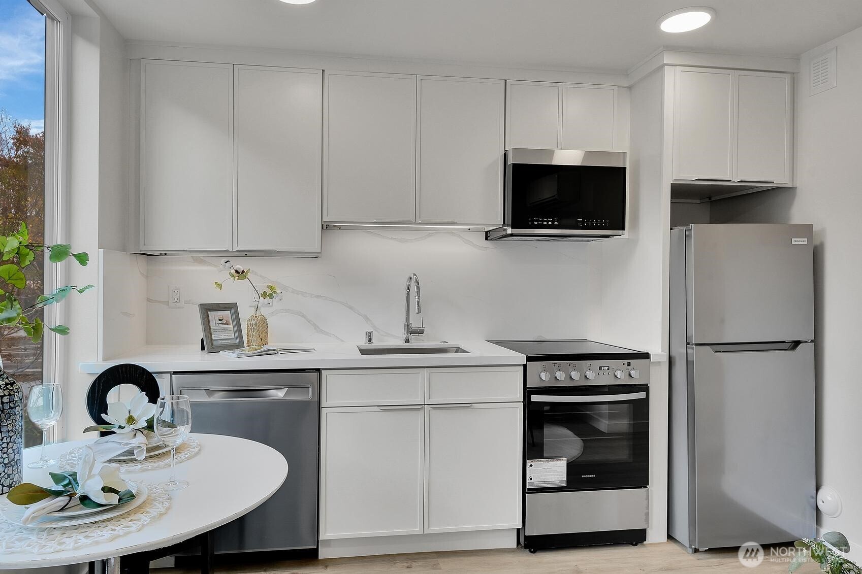 2372 Franklin Avenue East Seattle, WA 98102 - Photo 17 of 32 a kitchen with stainless steel appliances a stove a sink a microwave and cabinets
