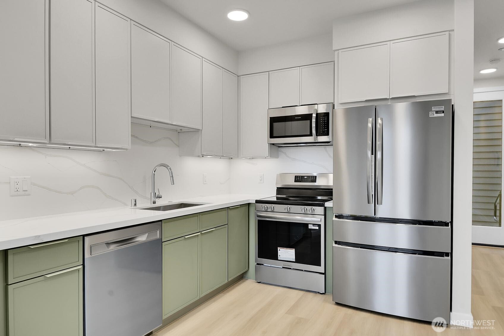 2372 Franklin Avenue East Seattle, WA 98102 - Photo 22 of 32 a kitchen with stainless steel appliances granite countertop a refrigerator stove a sink and dishwasher with wooden floor