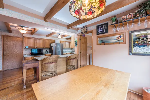 a bedroom with a bed a table and chairs