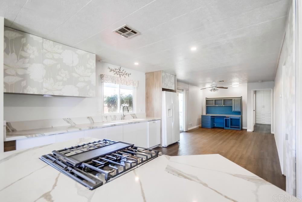 a kitchen with a stove and a refrigerator