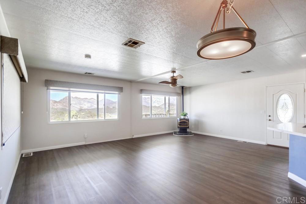 9500 Harritt Road, Unit 70 Lakeside, CA 92040 - Photo 4 of 21 an empty room with wooden floor and windows