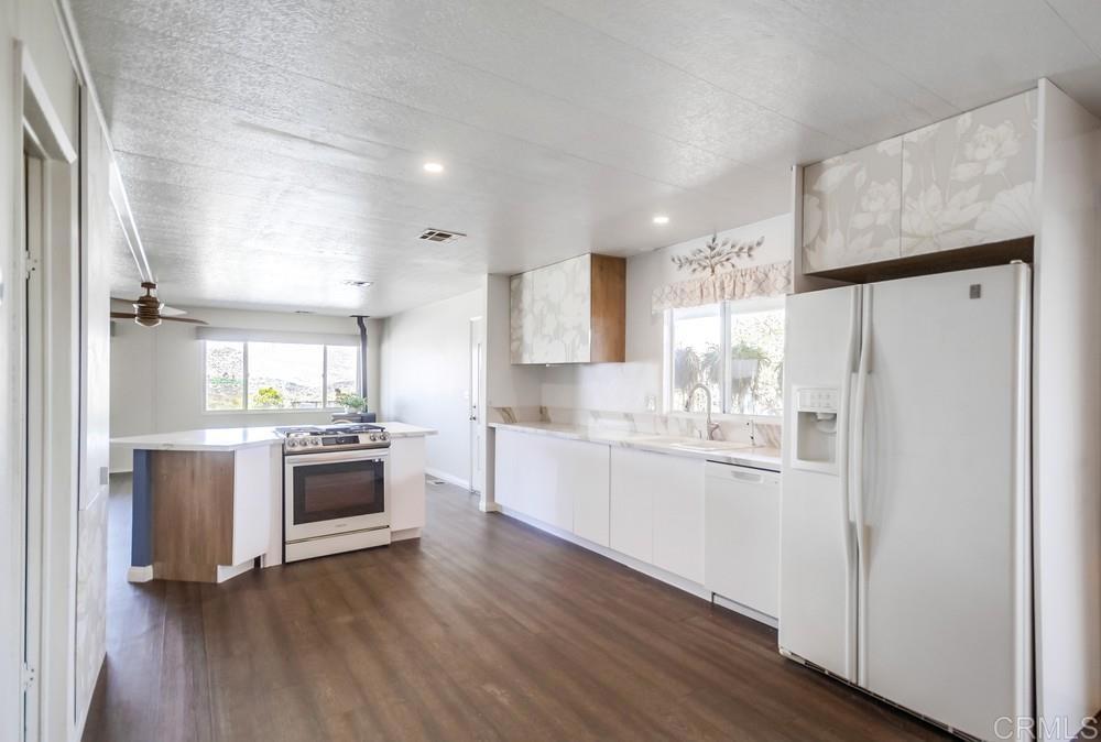 9500 Harritt Road, Unit 70 Lakeside, CA 92040 - Photo 8 of 21 a kitchen with granite countertop a refrigerator stove and sink