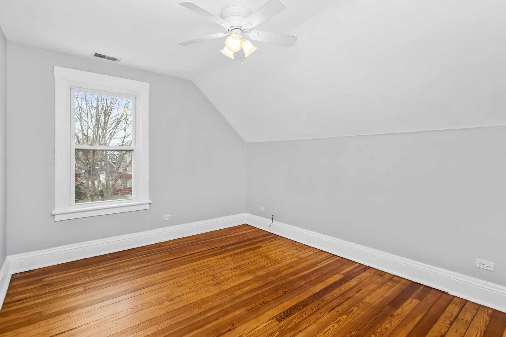 1116 Darrow Avenue, Unit 2F Evanston, IL 60202 - Photo 2 of 15 a view of empty room with wooden floor and fan