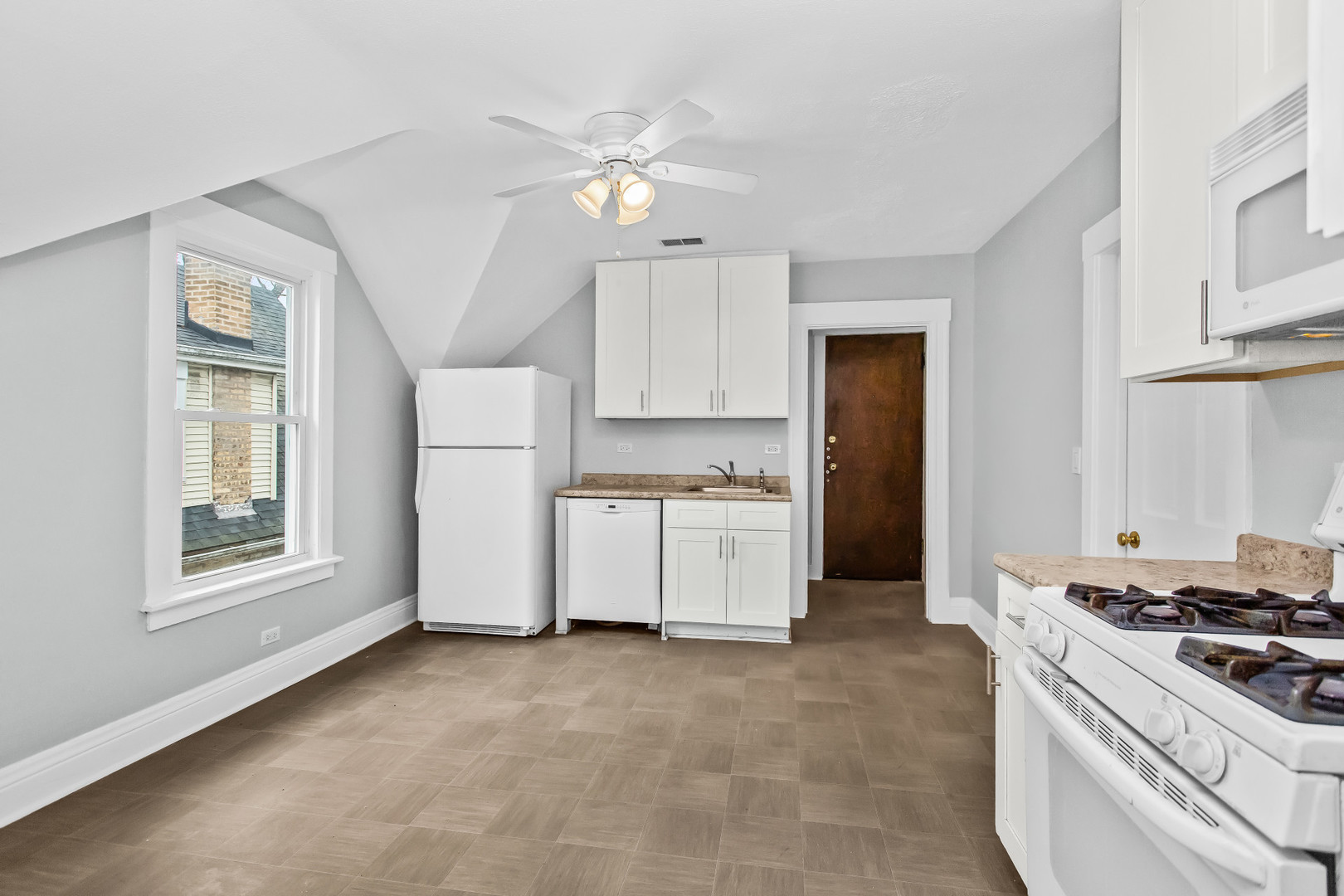 1116 Darrow Avenue, Unit 2F Evanston, IL 60202 - Photo 5 of 15 a kitchen that has a lot of white cabinets and stainless steel appliances