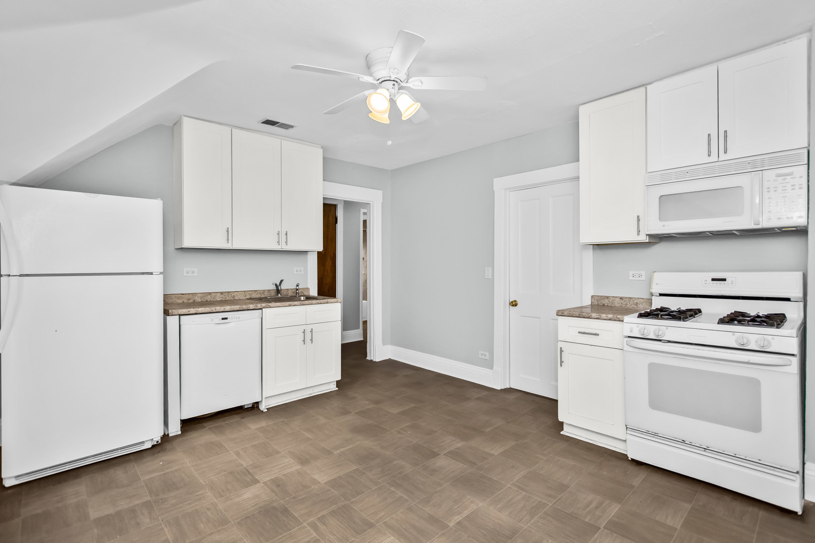 1116 Darrow Avenue, Unit 2F Evanston, IL 60202 - Photo 6 of 15 a kitchen with cabinets appliances and a sink