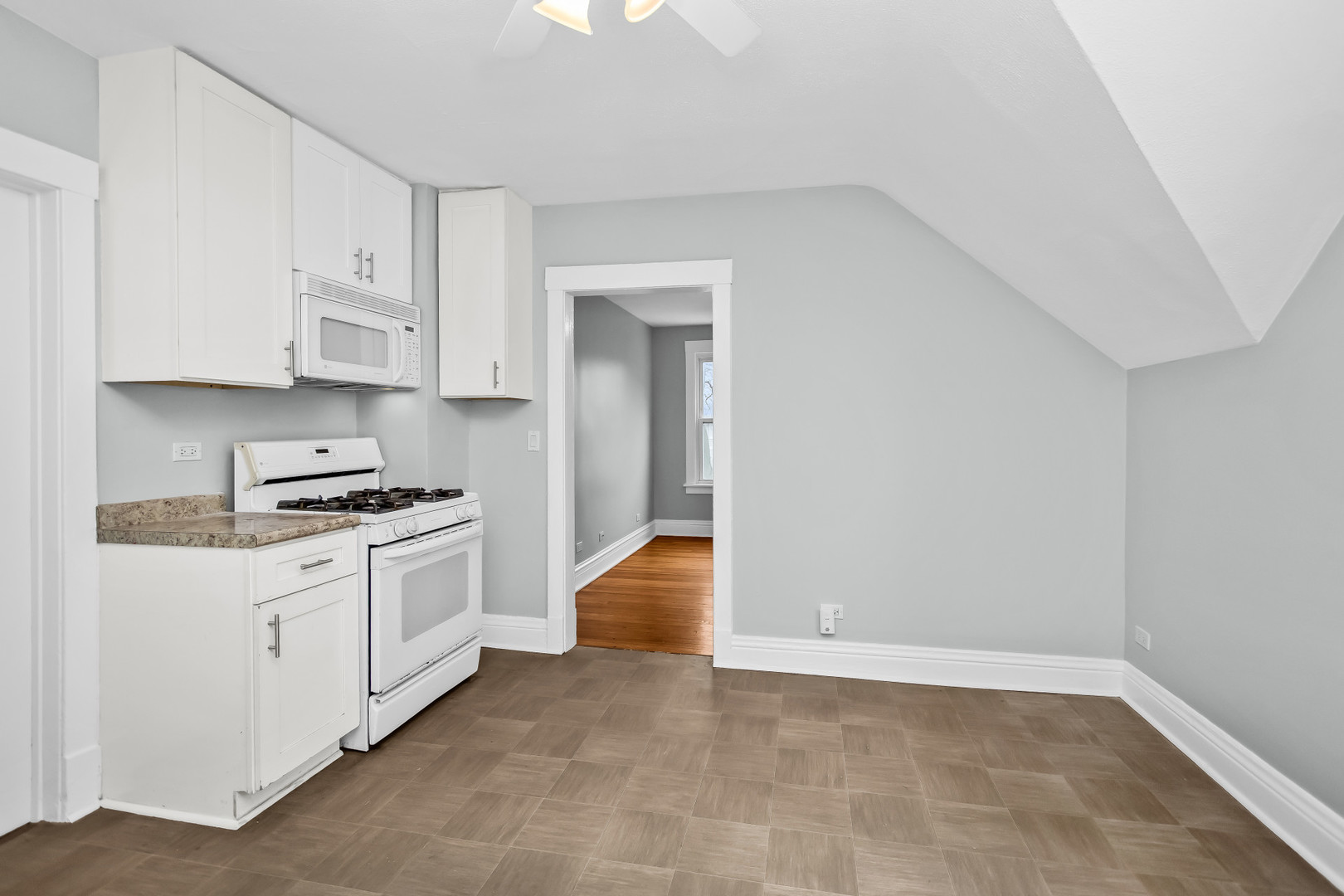 1116 Darrow Avenue, Unit 2F Evanston, IL 60202 - Photo 7 of 15 a kitchen with stainless steel appliances granite countertop a stove and a refrigerator