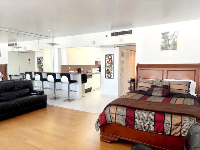a bedroom with furniture and wooden floor