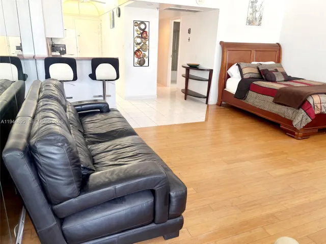 a bedroom with furniture and a large window