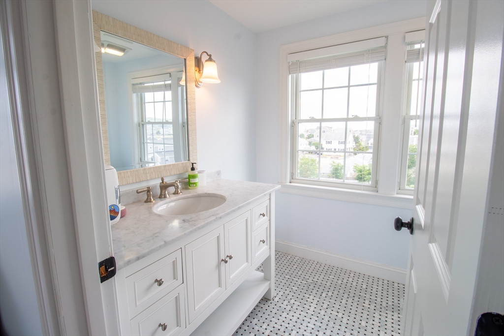 117 River Street Scituate, MA 02050 - Photo 20 of 23 a spacious bathroom with double vanity and a mirror